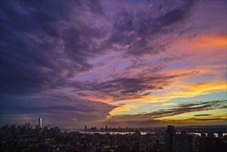 Dramatic sky over city at sunset. New York City, New York, USA.