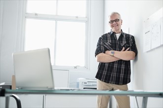 Portrait of smiling man in modern office.