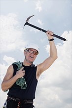 Portrait of man with climbing equipment outdoors.