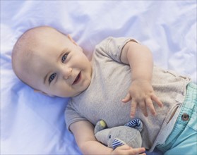Portrait of baby boy (6-11 months) lying down