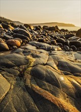Rocks on beach at sunrise