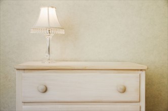 Electric lamp on wooden dresser