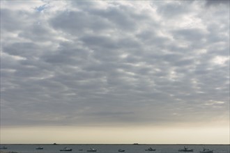 Cloudscape above sea with boats