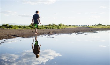 Boy (6-7) walking on lake shore