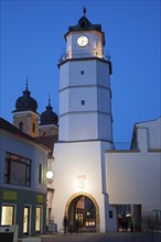 Illuminated clock tower at dusk