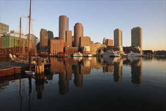 City waterfront reflected in harbor