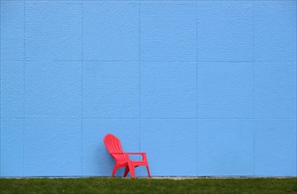 Red chair by blue wall