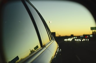 Sunset in city reflected in car's window
