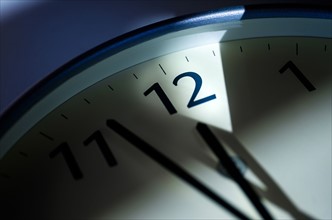 Close-up of clock on blue background.