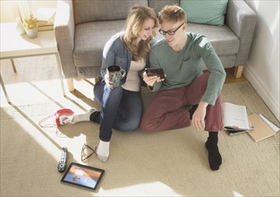 Young couple watching movie on digital tablet.