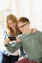 Young couple watching movie on smart phone.