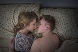 Young couple sleeping in bed.
