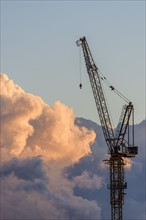 Crane against sky at sunset.