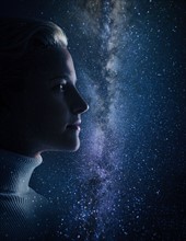 Studio shot of young woman looking at stars.