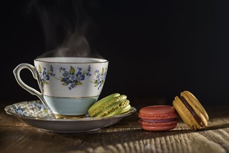 Tea and macaroons on table.