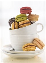 Macaroons in coffee cup.