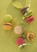 Macaroons on green tablecloth.