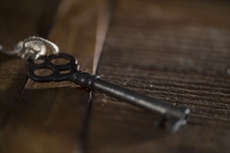 Skeleton key on wooden table.