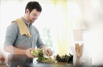 Man preparing food in kitchen.