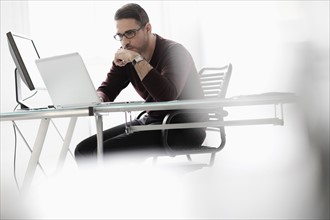 Man using laptop in office.