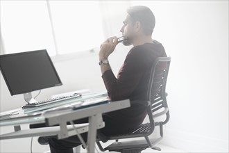 Man sitting at desk in office.