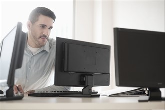 Man using computer in office.