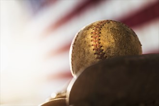 Close-up of baseball glove and ball.