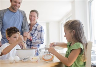 Family with two children (6-7, 8-9) preparing food