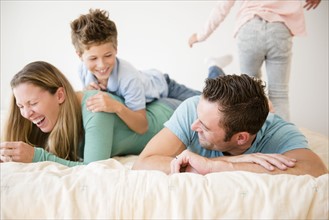 Family with two children (6-7, 8-9) in bedroom