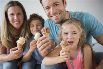 Family with two children (6-7, 8-9) holding ice cream cones
