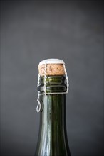 Studio shot of champagne bottle with cap on black background