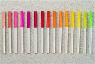 Multi colored felt tip pens in a row