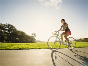 Young woman cycling in park