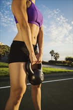 Young woman exercising with kettlebell