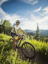 Woman during bicycle trip in mountain scenery