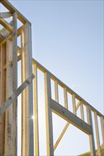 Wooden construction frames against clear sky