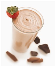 Chocolate smoothie decorated with strawberry and pieces of chocolate