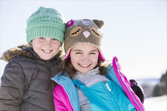 Portrait of children (8-9, 10-11) in winter clothing