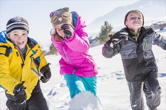 Children (8-9, 10-11) running in snow
