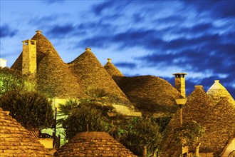 Traditional roofs of trulli houses at sunset