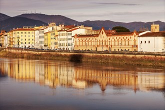 Townhouses by Arno river at sunset