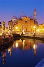 Illuminated buildings of Prato della Valle with statues at dusk, Padua