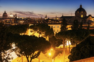 Illuminated townscape with domes at sunset