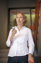 Woman wearing white shirt using mobile phone
