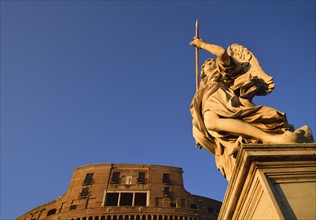Statue of angel and Castle Sant' Angelo against clear sky