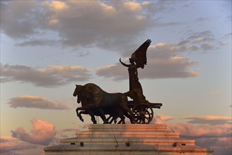 Statue of goddess Victoria on Altare della Patria at sunset
