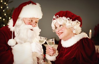 Santa and Mrs. Claus drinking champagne.