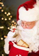Portrait of Santa Claus holding nutcracker toy.