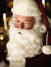 Portrait of Santa Claus winking.