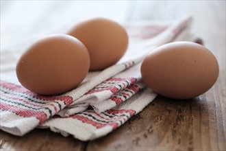 Eggs lying on tablecloth.